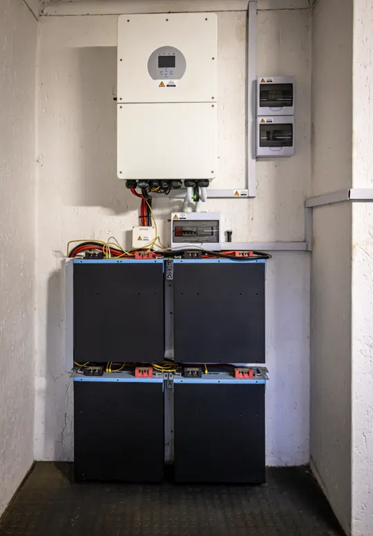 Wall-mounted storage inverter above four battery modules